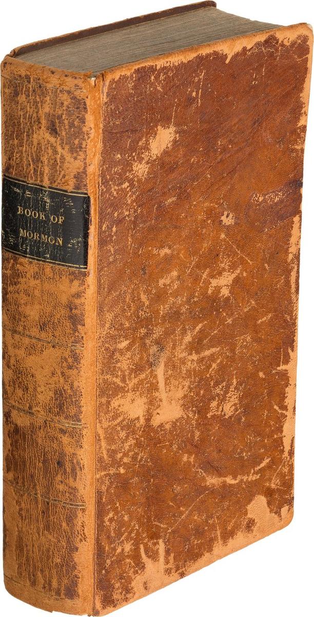 Old brown, first edition of The Book of Mormon, scuffed and worn