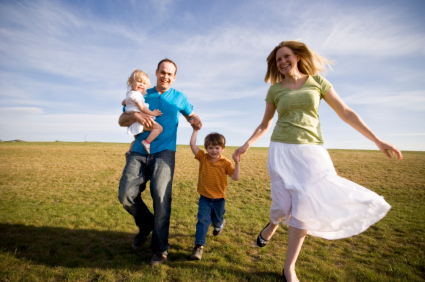 Happy family in a grassy field